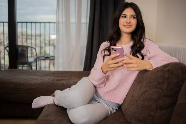 istock Happy young woman using phone 1473891739