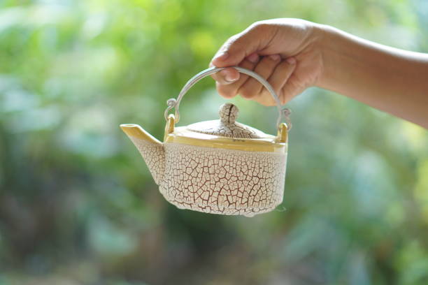 istock Female human hand holding a cup of coffee 1473892883