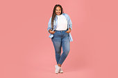 Black Lady Posing Wearing Plus Size Clothes Over Pink Background