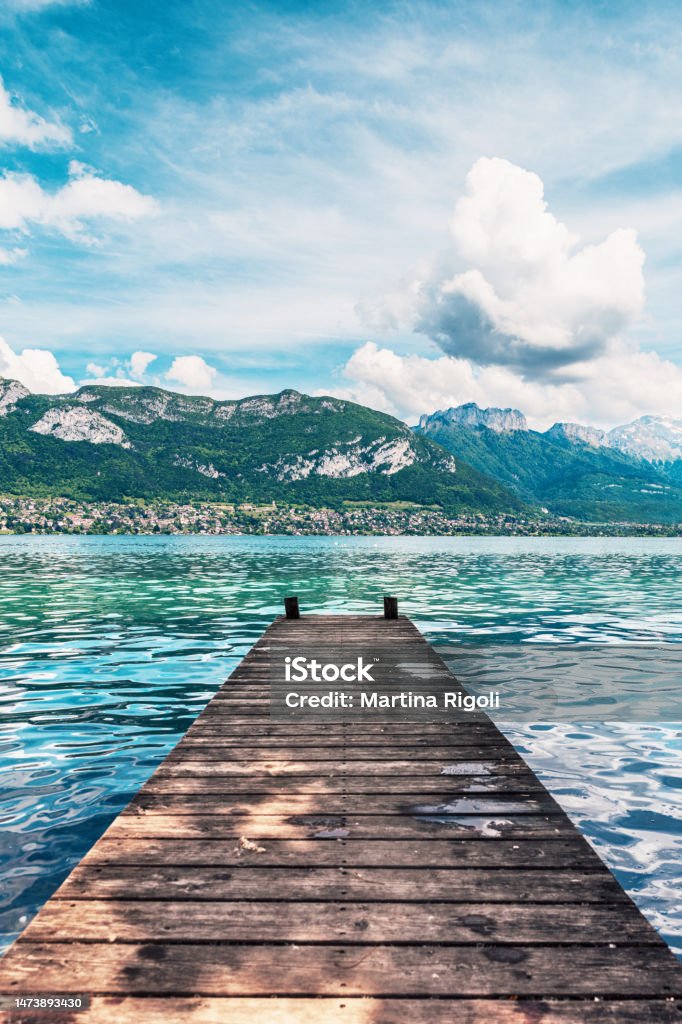 Wooden jetty perspective and beautiful view of Lake Annecy Wooden jetty perspective and beautiful view of Lake Annecy. Lake Annecy (French: Lac d'Annecy) is a perialpine lake in Haute-Savoie in France. It is named after the city of Annecy.It is the third-largest lake in France and it is known as "Europe's cleanest lake" because of strict environmental regulations introduced in the 1960s. Annecy Lake Stock Photo