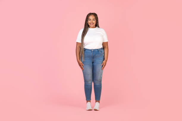 Happy Black Plus Size Female Model Posing Over Pink Background