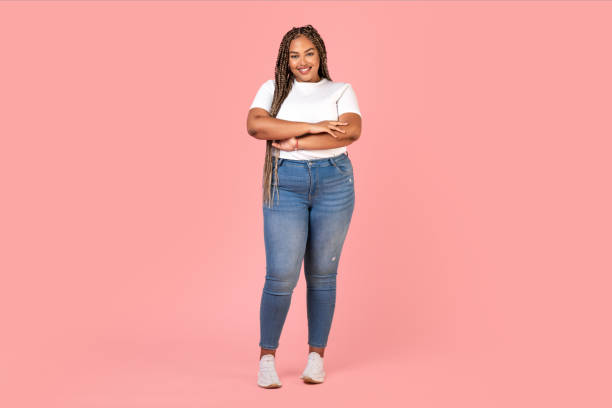 istock Attractive Black Plus Size Woman Model Standing Over Pink Background 1473893905