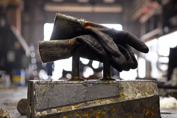 istock Interior of a metal foundry. Used leather protective gloves. 1473897614