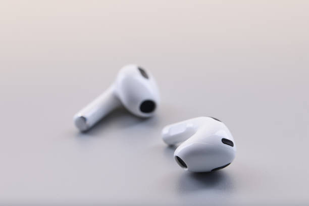 istock Wireless white stylish bluetooth headphones on gray background 1473897966