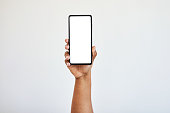 Hand holding phone, blank screen with mockup and black woman hands in studio isolated on white background. Technology, connect and zoom on space on smartphone for website, social media or advertising