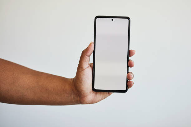 istock Hand, phone screen with mockup with zoom on black woman hands in studio isolated on white background. Technology, connect and space information on smartphone for website, social media or advertising. 1473900711