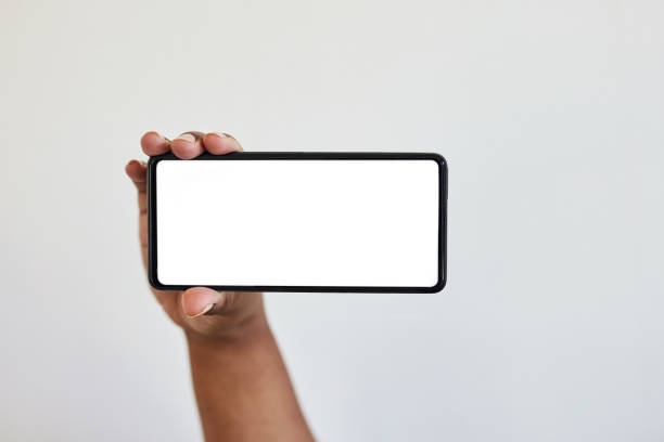 istock Hand, phone and screen with mockup, zoom on black woman hands in studio isolated on white background. Technology, connect and space information on smartphone for website, social media or advertising. 1473900902