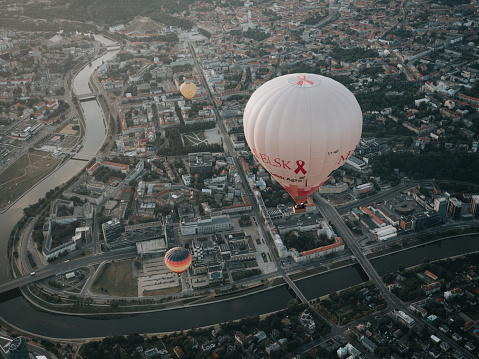 Vilnius, Lithuania - August 28, 2022: Colorful hot air balloons above Old town of Vilnius city and the Neris river