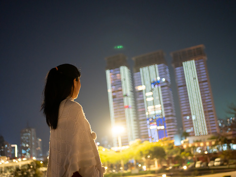woman looking at city night view