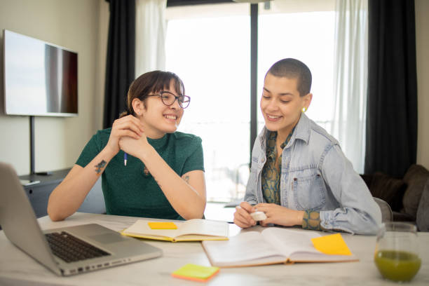 istock Two happy friends are learning together online 1473905169