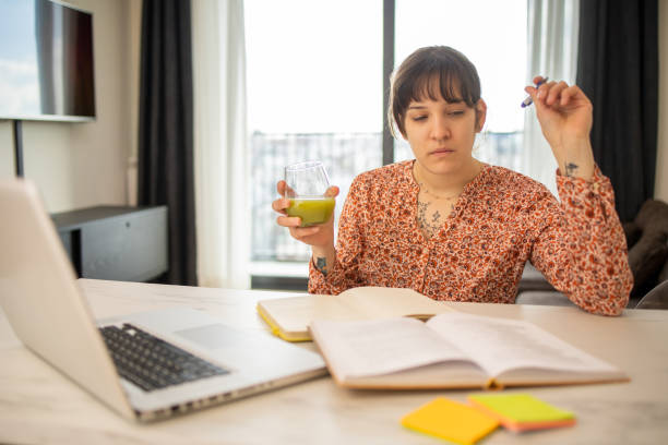 istock Happy young woman is learning online 1473905175