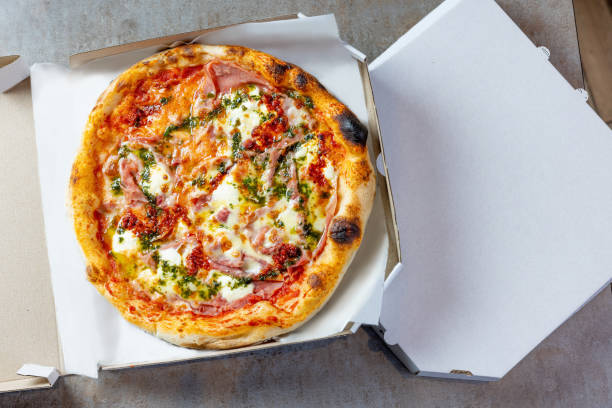 istock Round baked Ham & Cheese pizza in open pizza box 1473905846
