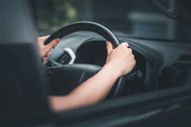 istock Asian man hand holding steering wheel. 1473906601