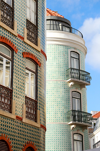 Old, colorful and bright typical facades in Lisbon with tiles