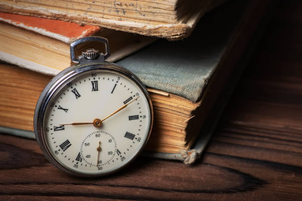 istock Old vintage watch on books background close up 1473910496
