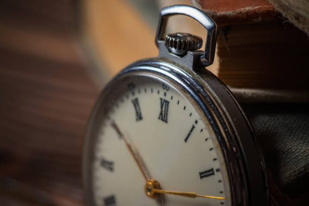 istock Pocket Watch and Old Book in Vintage Style 1473910529