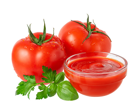 Composition of red tomato, sauce and greens isolated on white background.
