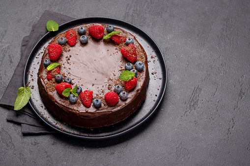 Chocolate cake dessert with fresh berries. With copy space