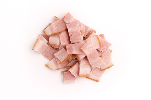 heap of sliced raw smoked bacon isolated on white background, pork meat strips pieces, package design element, top view