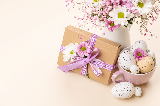 Gift box, Easter eggs and flowers bouquet with space for your greetings