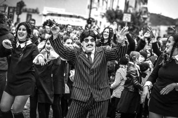 cosplayers portraying characters from the Addams Family television series Diano Marina , Italy, 02-03-2023 - Dancing cosplayers wearing Wednesday Addams costumes, travel reportage the addams family photos stock pictures, royalty-free photos & images
