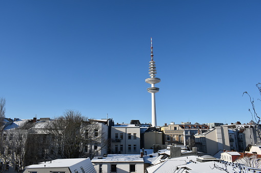 Hamburg TV tower and roofs on a cold sunny snowy day