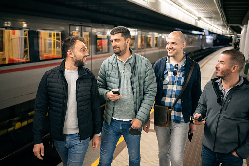 Group of mid-adult Caucasian men at the subway station