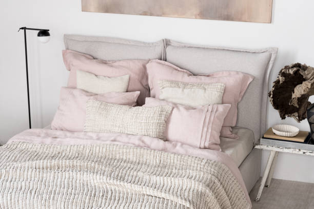 istock Cozy bed with pink and beige bedclothes 1473926862