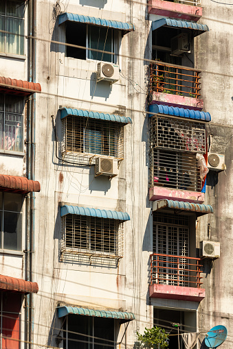 Yangon, Myanmar - Dec 19, 2019: Facade of an old and dilapidated residential building in Yangon, Burma, Myanmar
