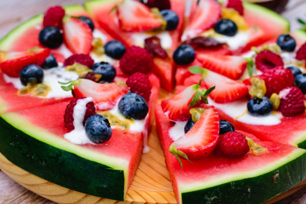 Closeup of watermelon pizza with berries and yogurt