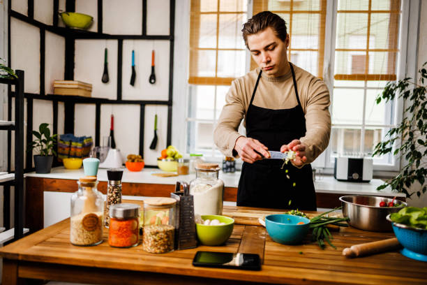 istock Chef puts in bowl prepared ingredients for healthy meal 1473928668