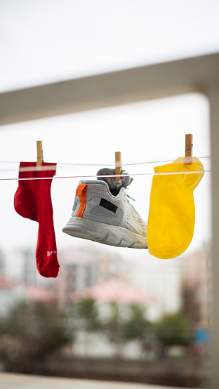 Sports socks and shoes hang on the hanger to dry