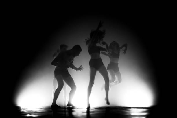 istock modern ballet dancers jumping. motion blur and smoke 1473929977