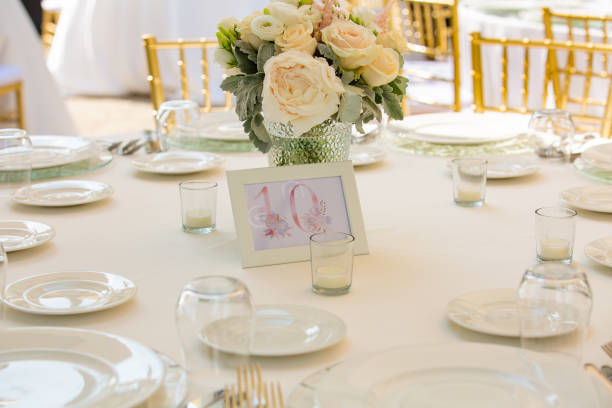 istock Wedding reception or other outdoor festive event. Luxury wedding reception dining table and gold decoration on a table. Table set for a party event or wedding reception. 1473930180