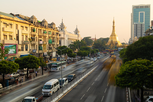 Yangon, Myanmar - Dec 19, 2019: Traffic on Sule Rd in the afternoon with Sule Pagoda in the background, Yangon, Burma, Myanmar