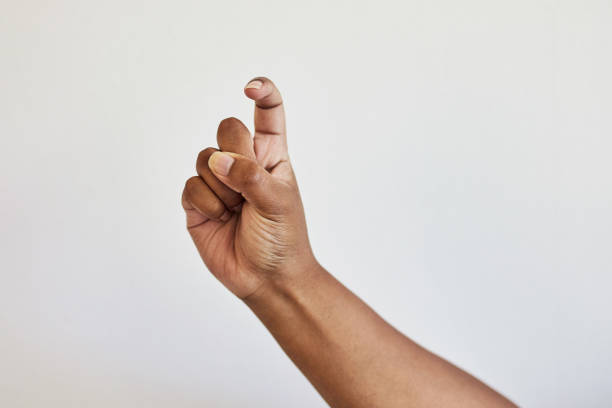 Sign language, message and hand for communication with a gesture isolated on a white background. Letter, symbol and person gesturing with fingers for conversation, English and signal on a backdrop