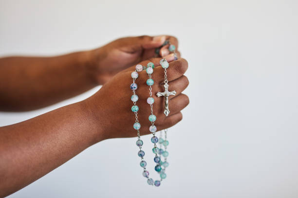 hands, person in prayer and rosary beads with cross, worship and christian religion isolated on white background. gratitude to god, belief and seek help, trust and praying, spiritual life with mockup - preacher church sermon gospel imagens e fotografias de stock