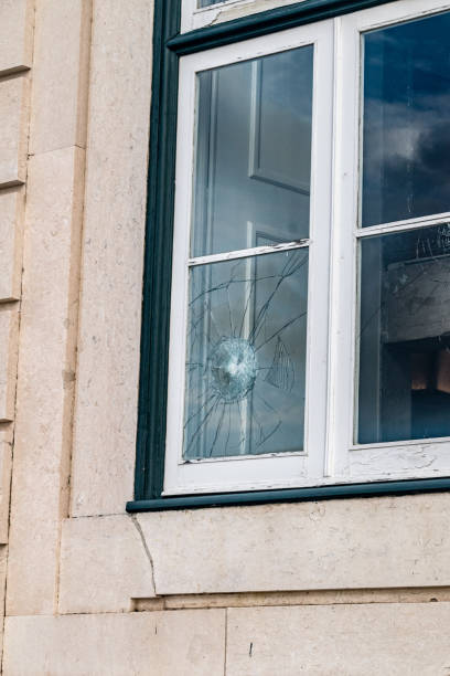 istock Broken window glass. Damaged window due to vandalism. 1473932340