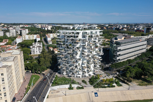 L'Arbre Blanc - White Tree is a unique residential bilding in Montpellier. The building was planned by: Sou Fujimoto, Nico­-las Laisné and OXO architects. The construction was finished in 2019 and contain 112 appartements on 17 storeys. the image was captured during spring season.