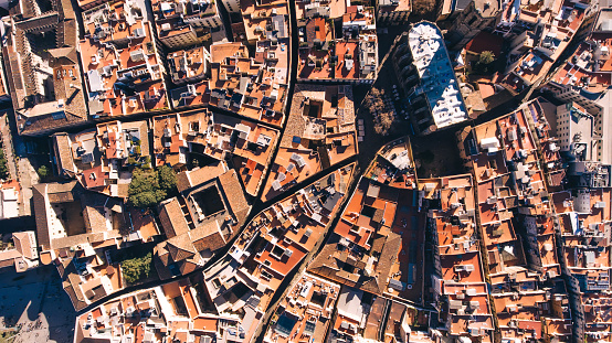 Drone view of old city with bright buildings and houses in aged neighborhood located in Barcelona Spain in sunny day