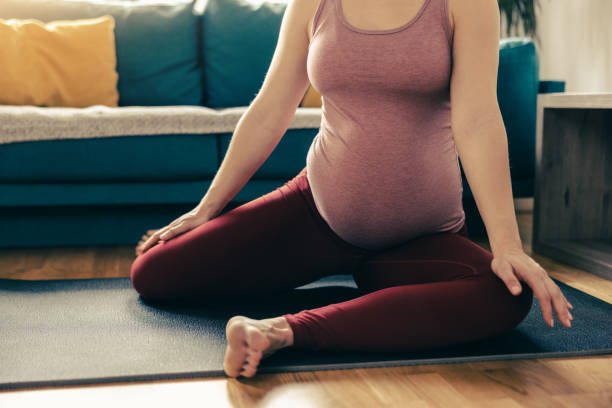 istock Unrecognisable Pregnant Woman Doing Mobility Exercises At Home 1473934068