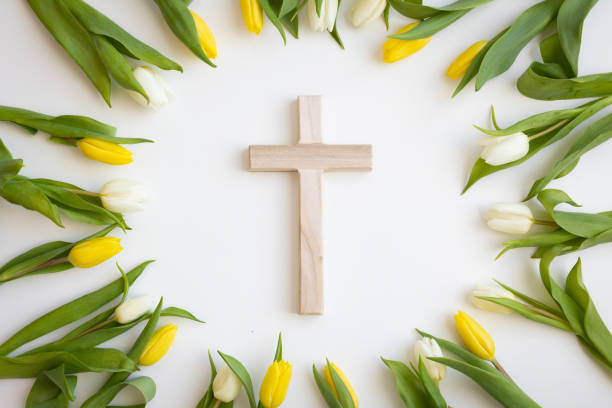 istock Cross framed by white and yellow tulips 1473934253