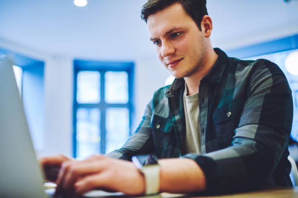istock Focused male typing on laptop during work 1473934285