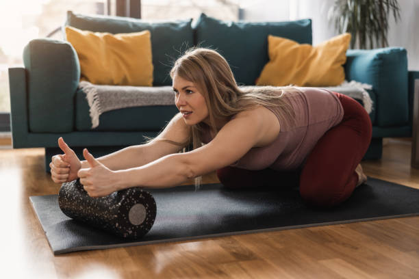 istock Pregnant Woman Doing Workout With Foam Roller At Home 1473934535