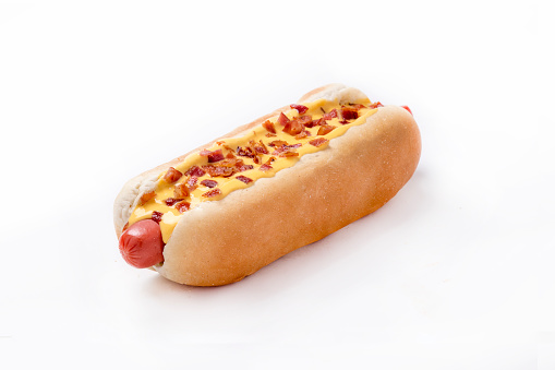 Isolated hotdog with German sausage, bacon, and cheese, white background.