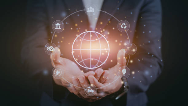 istock Businessman holding light bulb with globe icons 1473939035
