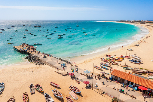 Pier and boats on turquoise water in city of Santa Maria, island of Sal, Cape Verde