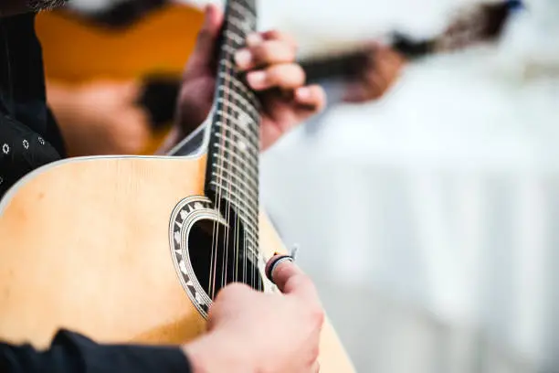 Close up of the guitar of a man playing traditional Portuguese music called fado