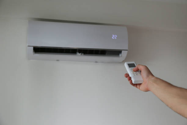 istock Man turning on the AC. 1473941929