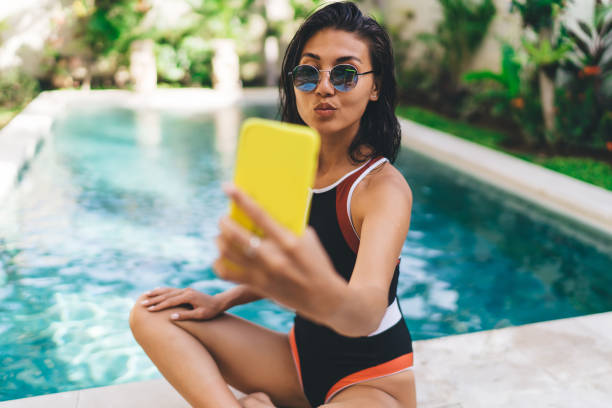 istock Woman with pouted lips taking selfie 1473948015